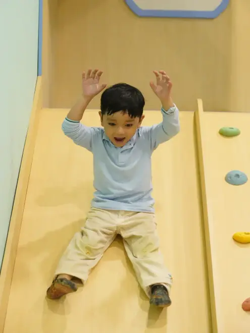 Child on the playroom slide