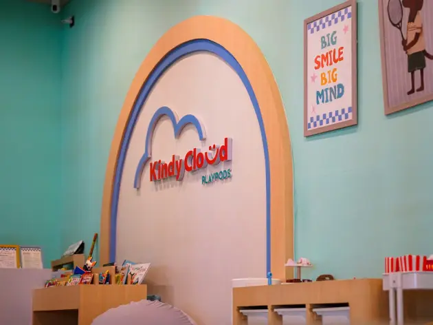 Bright kids' playroom with toys, books and a mural