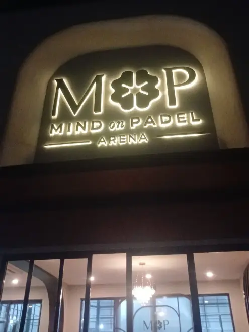 Illuminated MOP Mind on Padel sign at night