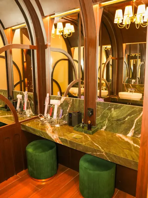 Marble vanity with brass mirror lights in the MOP bathrooms